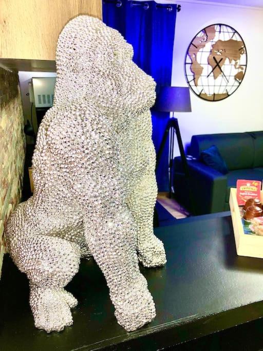 a large white dog statue sitting on a table at La marbrière, Parking gratuit, proche centre ville in Sens