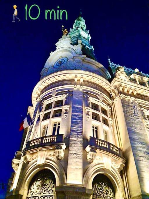 a building with a clock on the top of it at La marbrière, Parking gratuit, proche centre ville in Sens