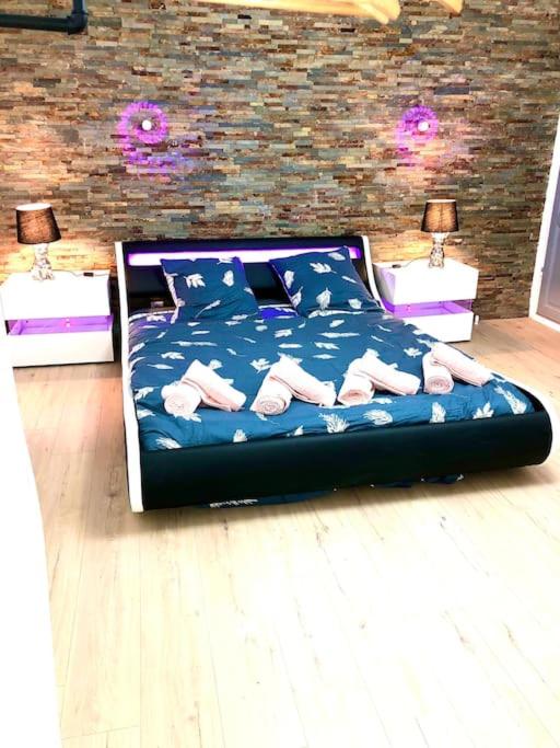 a bedroom with a bed with flip flops on it at La marbrière, Parking gratuit, proche centre ville in Sens