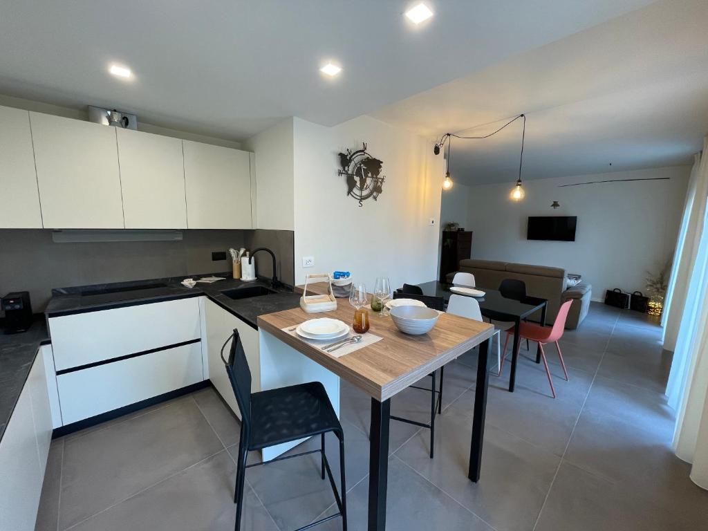 a kitchen and living room with a table and chairs at Lucia Holiday Apartments in Lazise