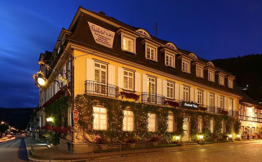 a large building on a city street at night at PRISMA Parkhotel Wehrle in Triberg
