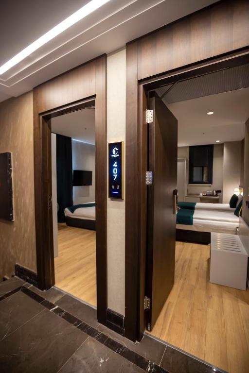 Postel nebo postele na pokoji v ubytování Costera Hotel