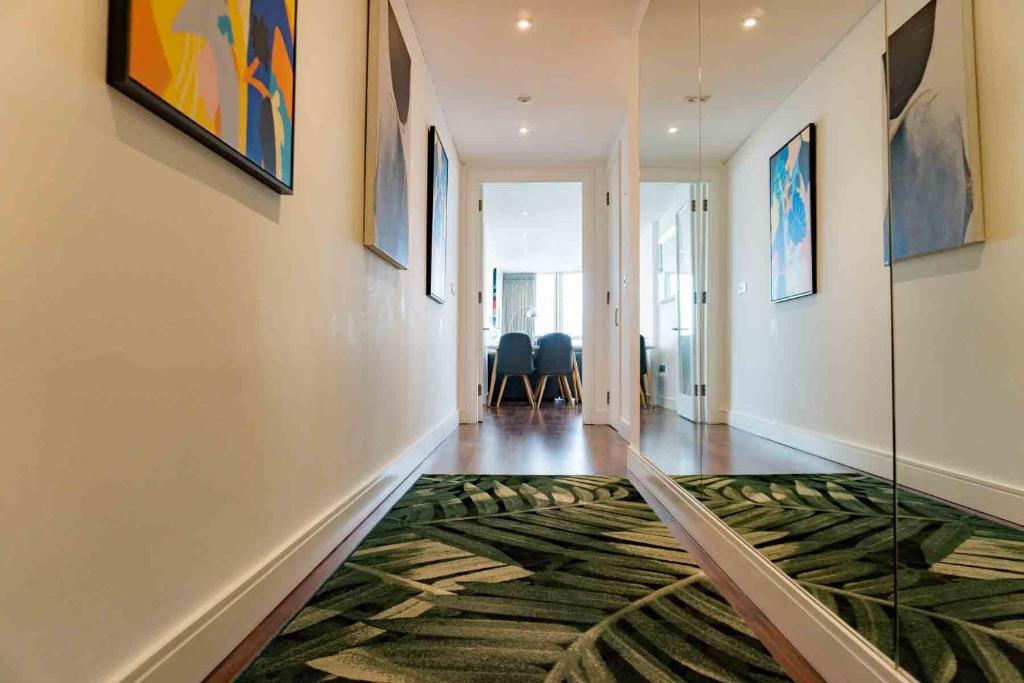 a hallway with a rug on the floor at Luxury 3 Bedroom 3 Bathroom Balcony Apartment - Gunwharf Quays Apartments in Portsmouth