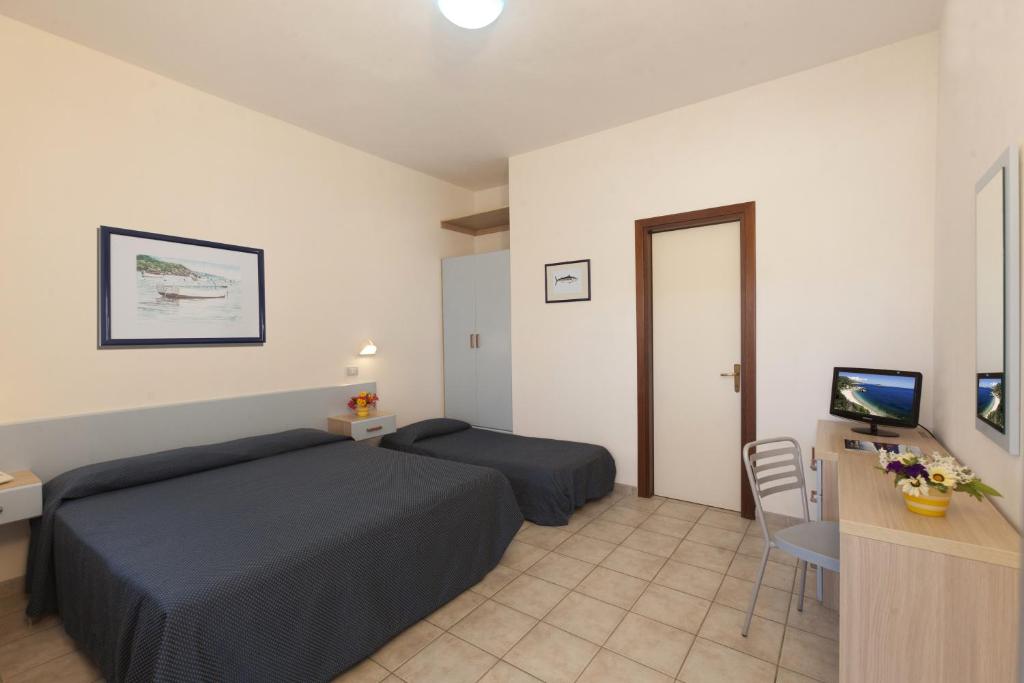 Postel nebo postele na pokoji v ubytování Hotel Le Palme