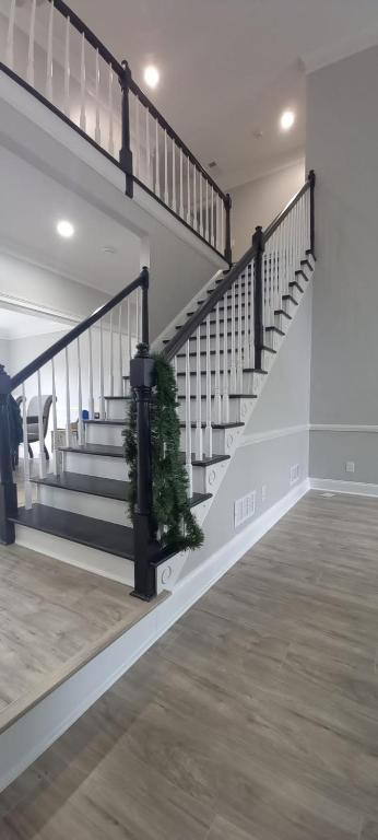 a staircase with a christmas tree in the middle at Chateau DreVal in Lawrenceville