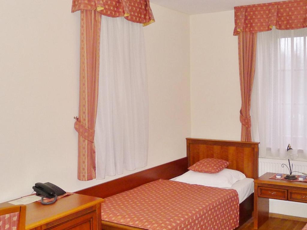 Postel nebo postele na pokoji v ubytování Hotel Nosal
