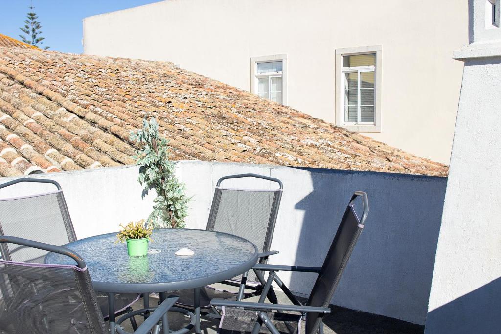 a blue table and chairs on a patio at The Tiles House in Faro