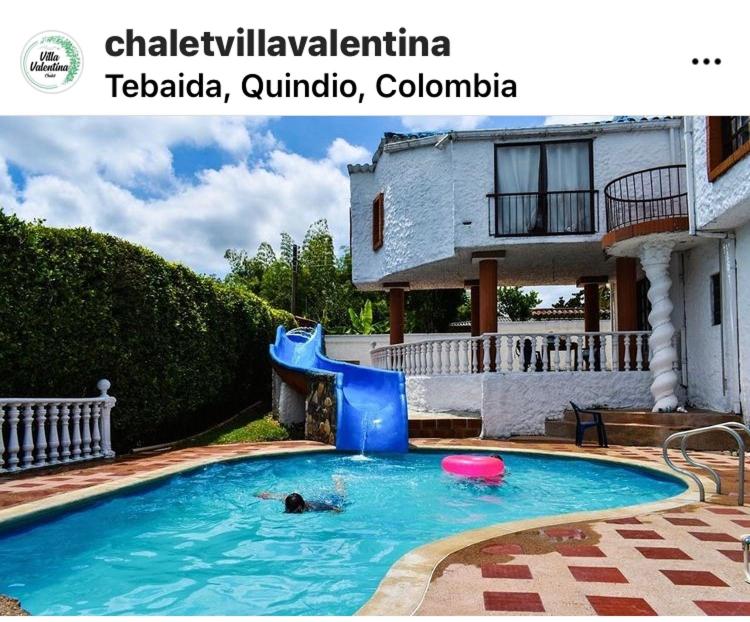 una persona en una piscina con tobogán de agua en Villa Valentina, en La Tebaida