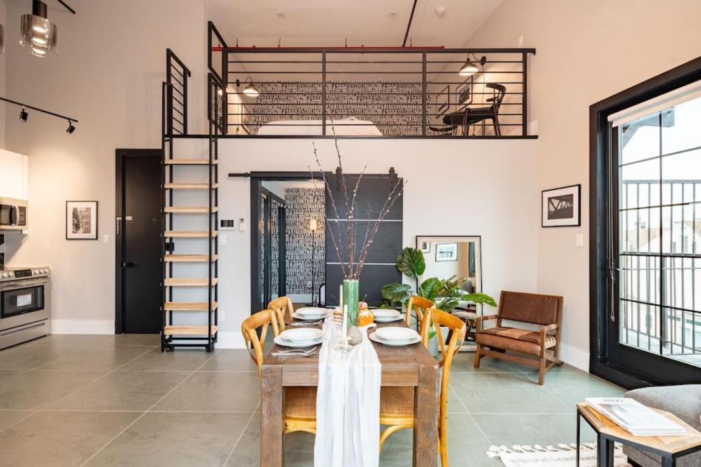 a living room with a table and chairs and a loft at Brooklyn Bay Unique Stay Private LUXURY LOFT in Brooklyn