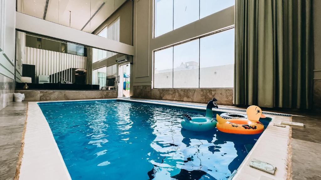 an indoor pool with an inflatable pool toy in a house at شاليه رويال الخبر - Royal Resort AL Khobar in Al Khobar
