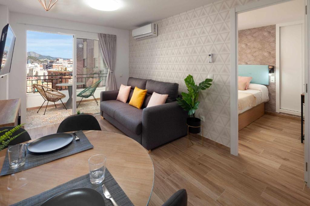 a living room with a couch and a table at Mirador La Catedral in Málaga