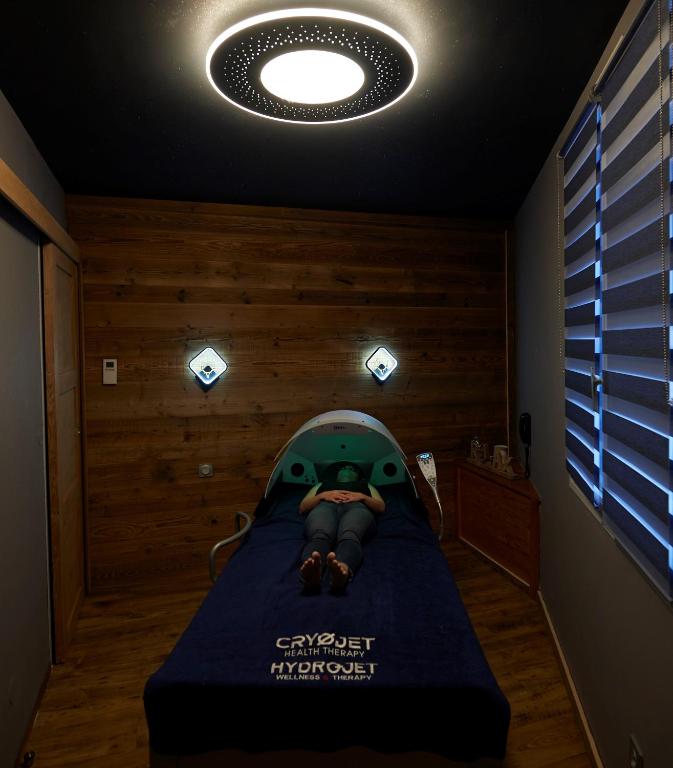 a room with a bed with a star wars poster on it at Logis Hôtel et Spa Le Christiania in La Salle-les-Alpes