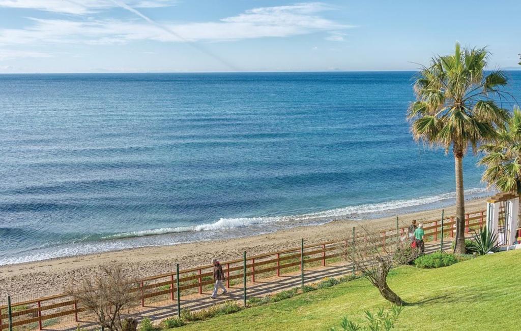 a beach with a wooden fence and the ocean at CT 190 - Pearl of Algaida I in Sitio de Calahonda
