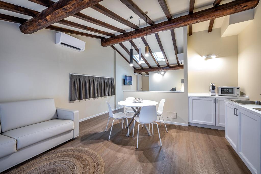 cocina y sala de estar con mesa y sillas en Garibaldi Luxury apartments, en Prato