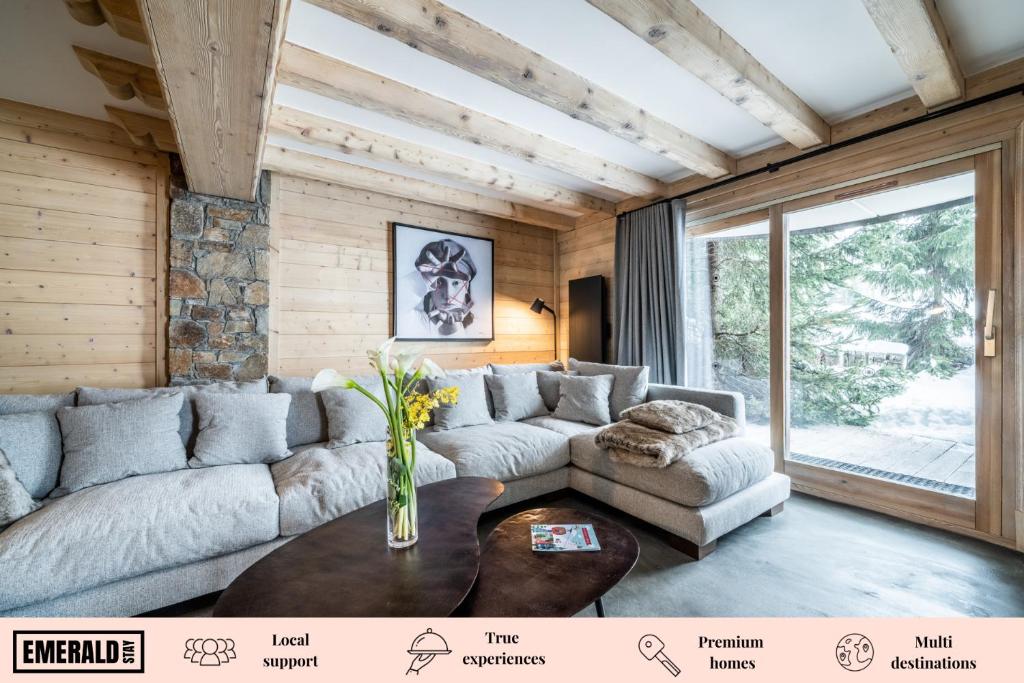 a living room with a couch and a table at Les Balcons de Pralong Courchevel 1850 - by EMERALD STAY in Courchevel