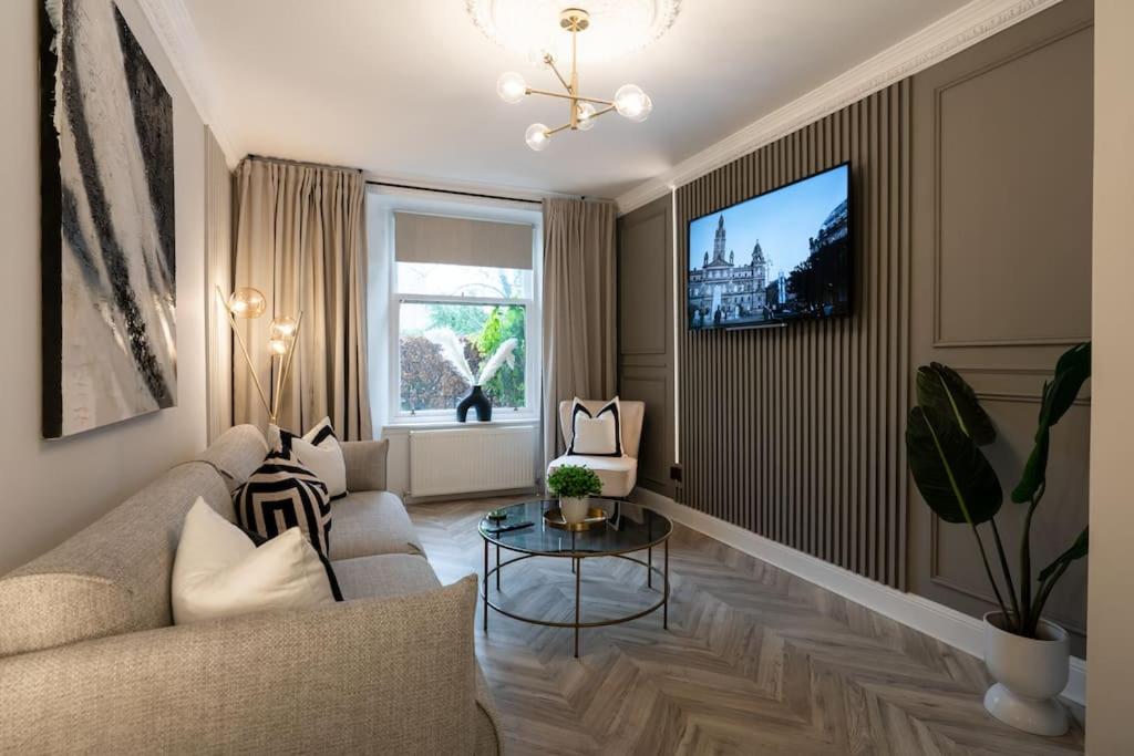 a living room with a couch and a tv at The Wilton Suite - Your Private 5* Escape! in Glasgow