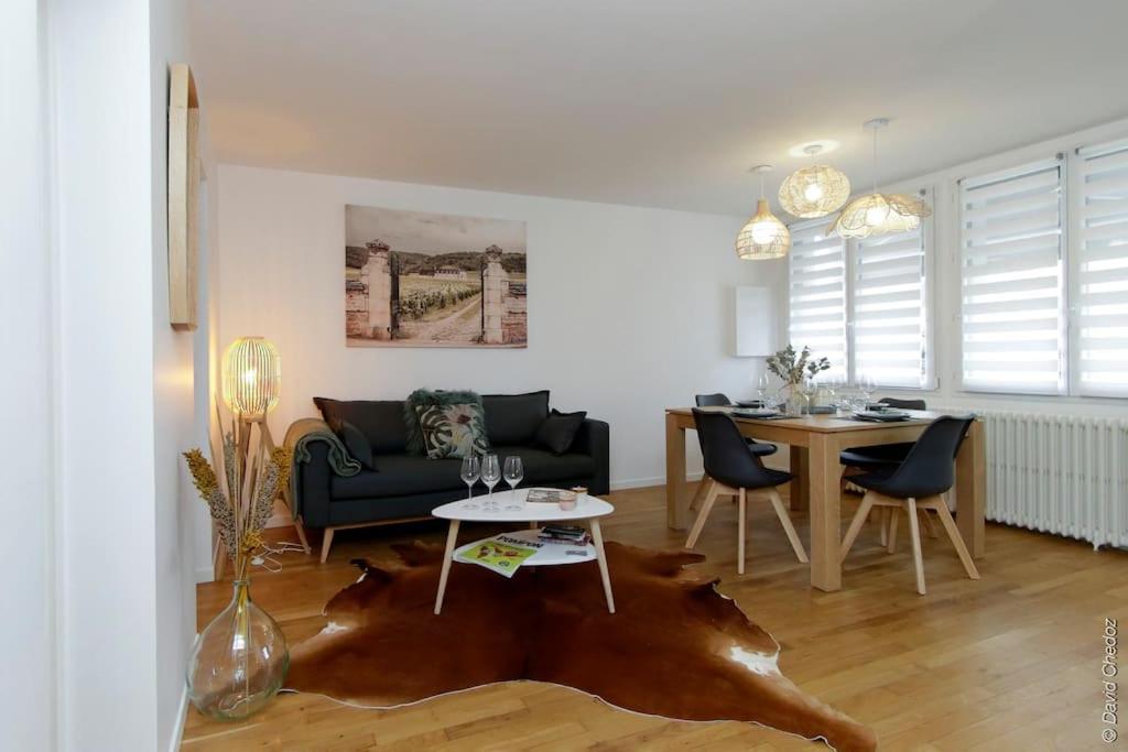 a living room with a couch and a table at Maison « De Ville en Vigne » in Chenôve