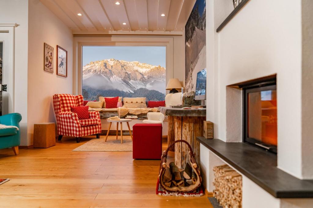 a living room with a view of a mountain at Alpin Appartement Reinhard Tritscher in Ramsau am Dachstein