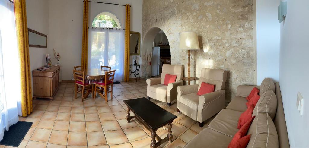 a living room with a couch and chairs and a table at Gîte Le Sirocco Le Moulin de Prédelles in Reillanne