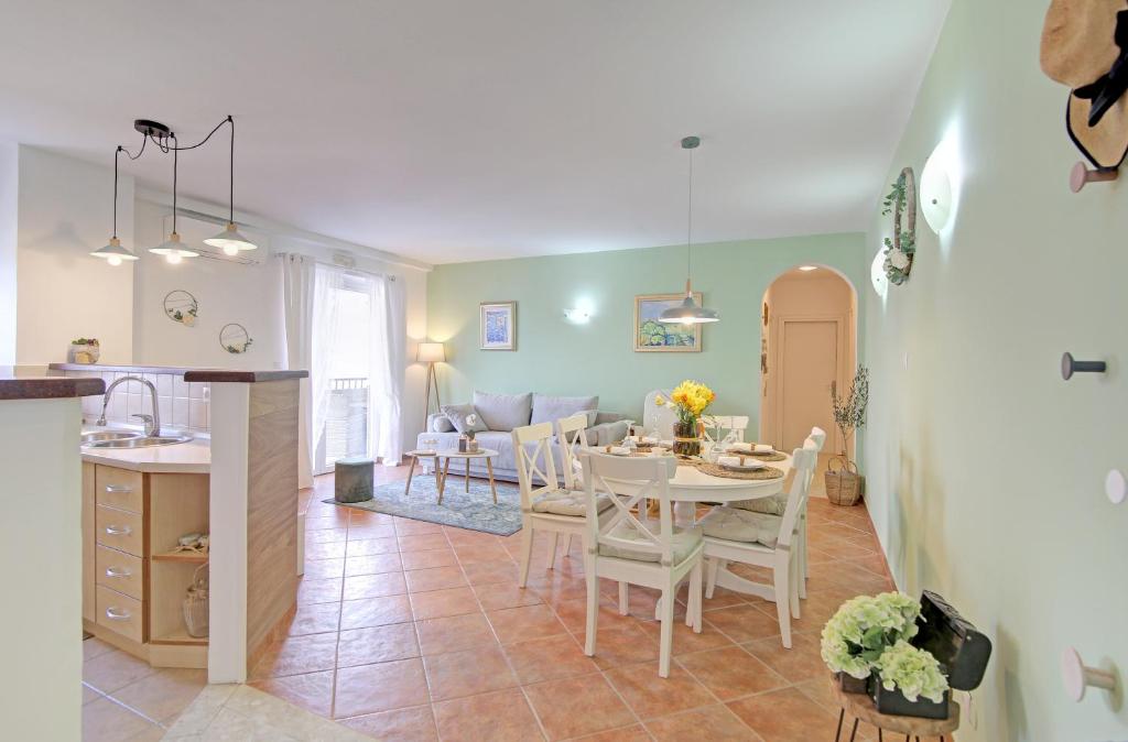a kitchen and living room with a table and chairs at Apartment Lana in Dubrovnik