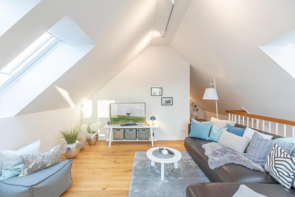 a living room with a couch and a table at Penthouse Tine in Husum