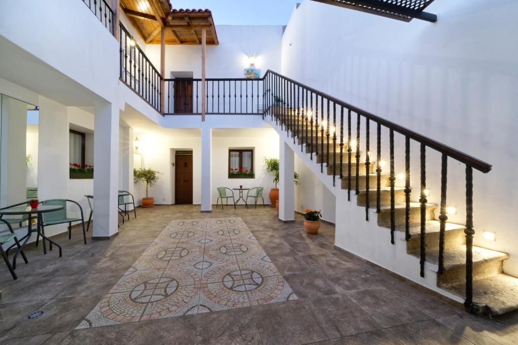 a hallway with stairs and a table and chairs at CASA VERDE Comfortable Air-Conditioned Modern Apartments in Ingenio