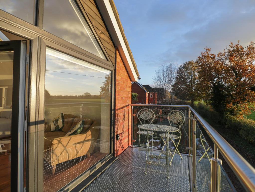 a balcony of a house with a table and chairs at Upper Annex in Calne