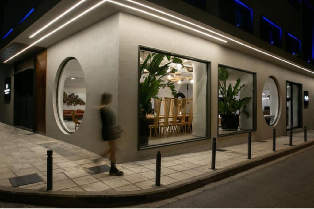 a rendering of a person looking into a store window at Elisabeth Boutique Hotel in Thessaloniki