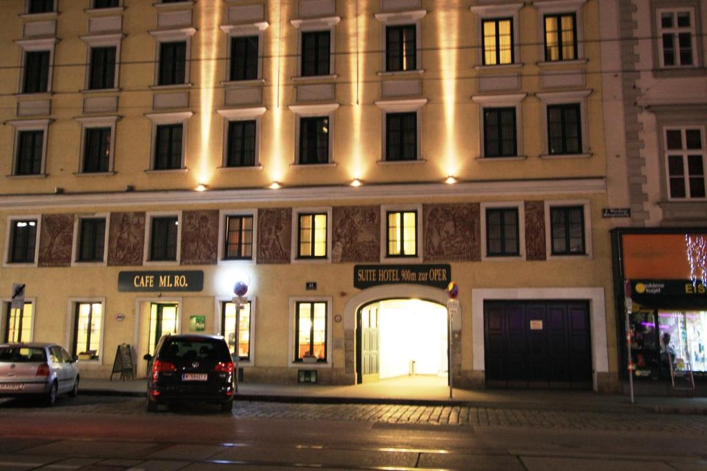 a car parked in front of a tall building at Suite Hotel 900 m zur Oper in Vienna