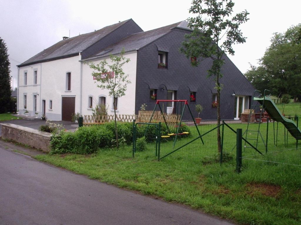 a house with a playground in front of it at Gîtes &quot;Les Framboisiers&quot; in Neufchâteau