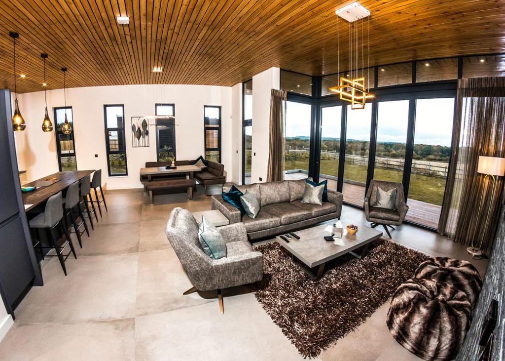 a living room with a couch and a table and chairs at Goosedale Lodges in Nottingham