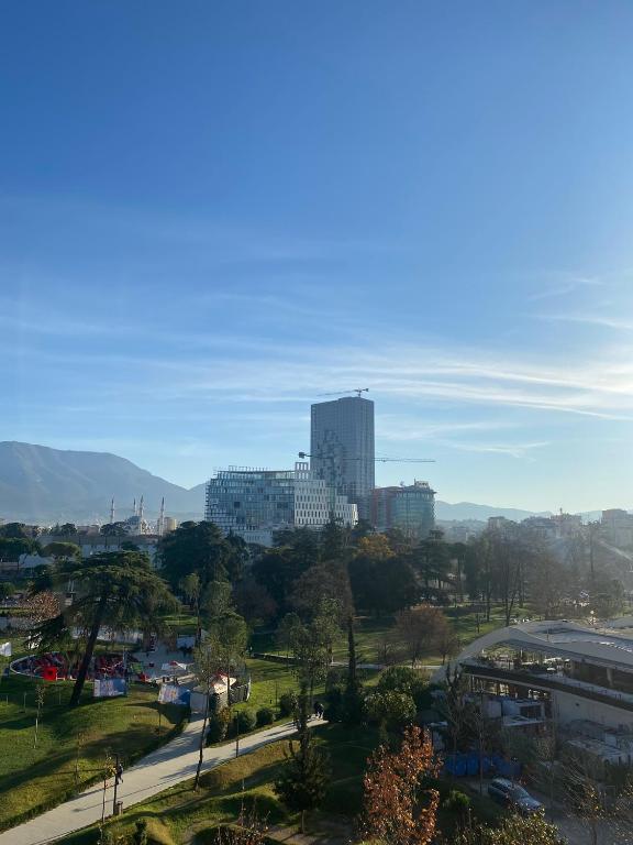 a view of a city with buildings in the distance at Central Park Rooms in Tirana