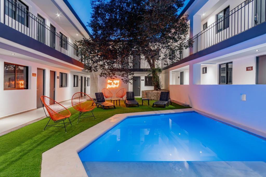 a swimming pool in the backyard of a house at Hotel Mody Merida in Mérida