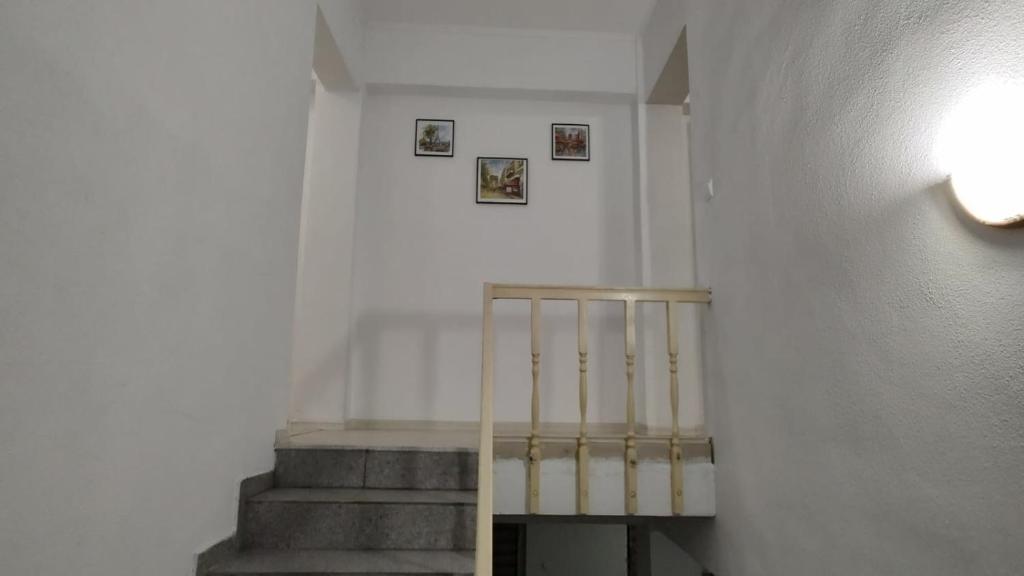 a staircase in a room with a stair case at Camera de la Bunici - o poarta catre oriunde 