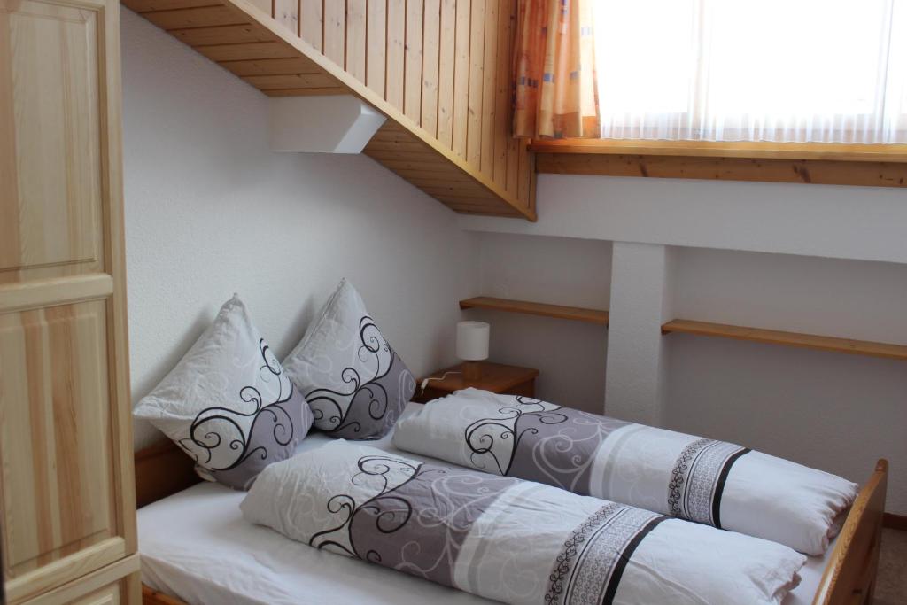 Postel nebo postele na pokoji v ubytování Ferienwohnungen Walserhof Malbun