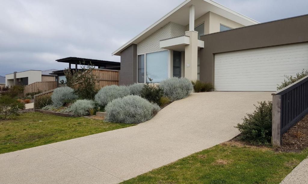 a house with a cross on the side of a driveway at ADAGIO in Point Lonsdale