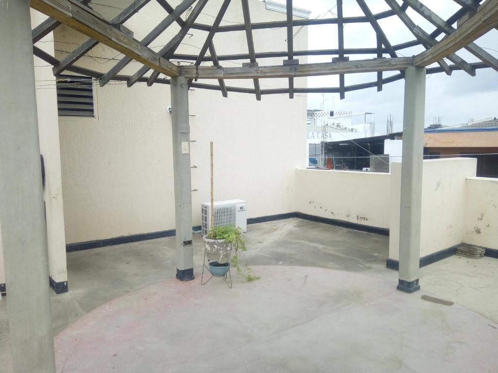 an empty room with a metal roof and a building at HOTEL en MONTERIA CITY in Montería