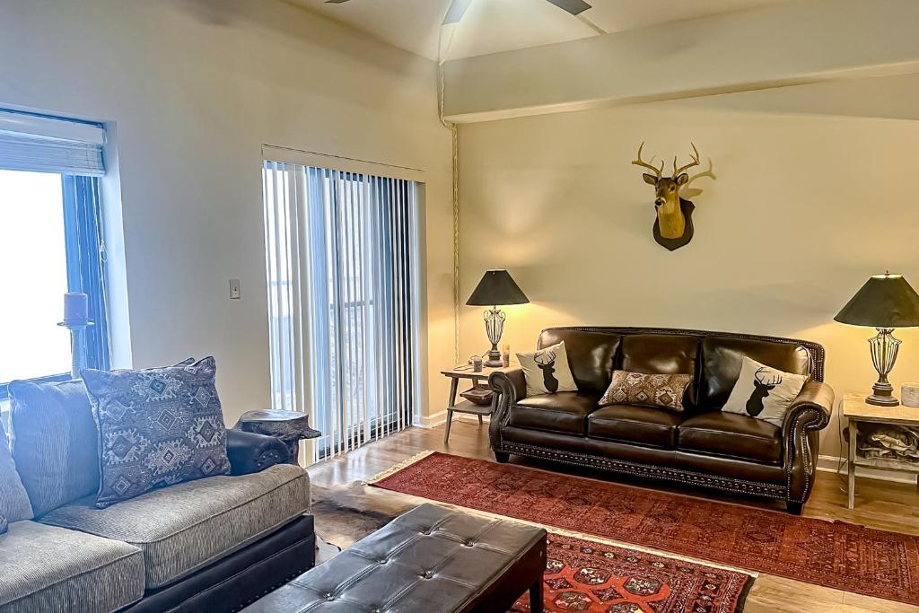 a living room with a couch and a deer head on the wall at Sunset Ridge in Sugar Mountain