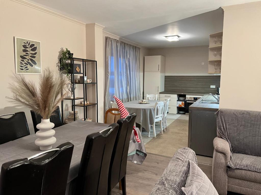 a dining room and living room with a table and chairs at Schöne Wohnung mit dem Garten in Jübek