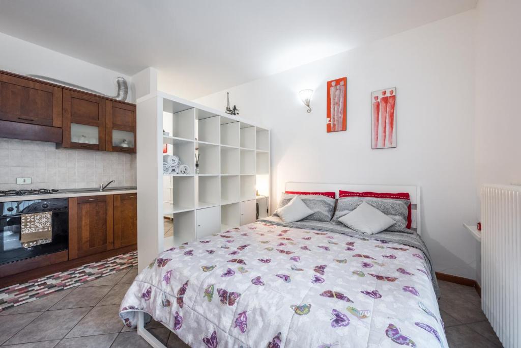 1 dormitorio con 1 cama y cocina en Delizioso flat in centro storico - Free WiFi & Netflix, en Massa Lombarda