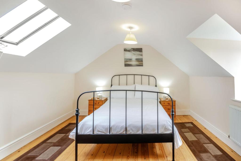 a bedroom with a bed in a attic at Bwythyn-y-Wennol in Abersoch