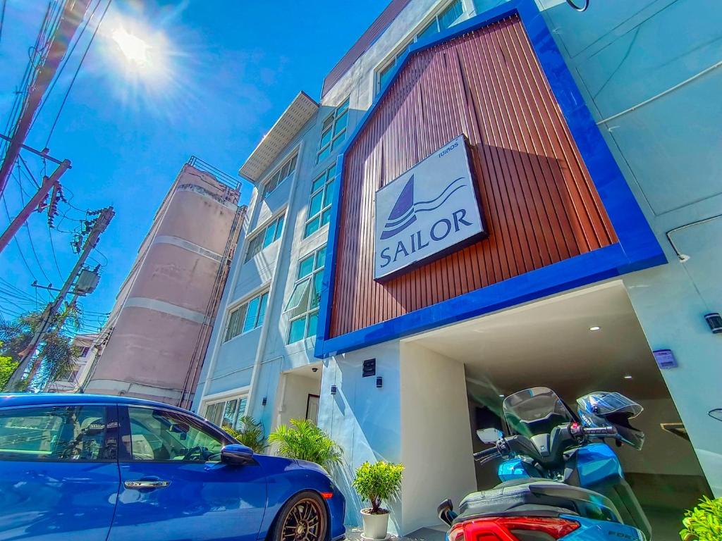 a blue car parked in front of a hotel at Sailor Hotel Pattaya in Pattaya South
