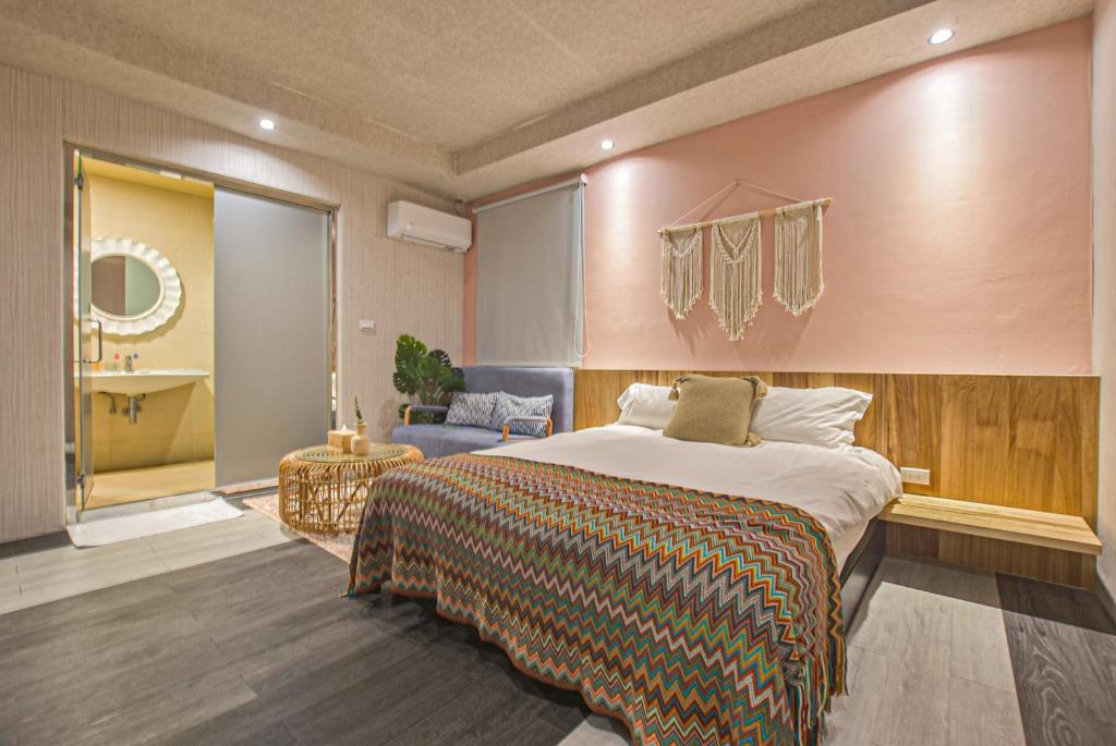 a bedroom with a large bed and a bathroom at Ashare Hotel in Jiaoxi