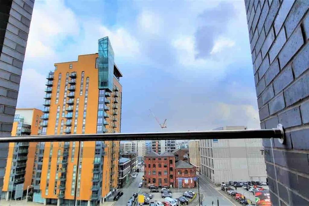 a view of a city street with tall buildings at Stylish 2 bedroom apartment Manchester City centre in Manchester