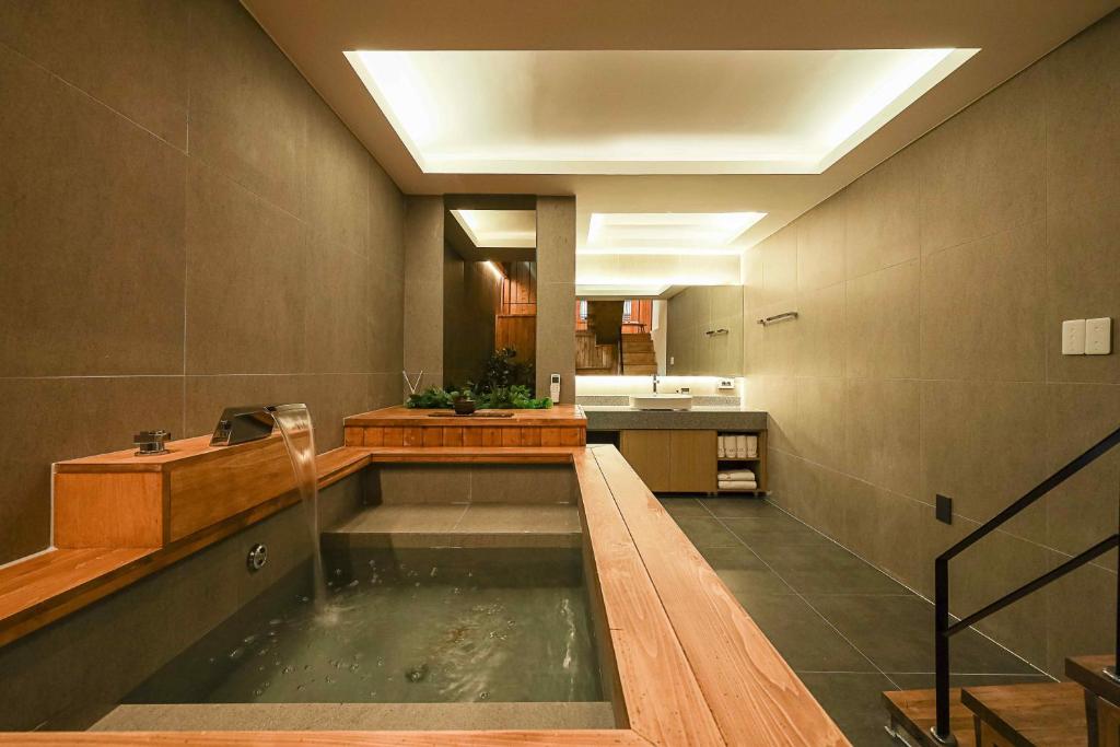a large bathroom with a pond in the middle of it at Luxury hanok with private bathtub - SN09 in Seoul