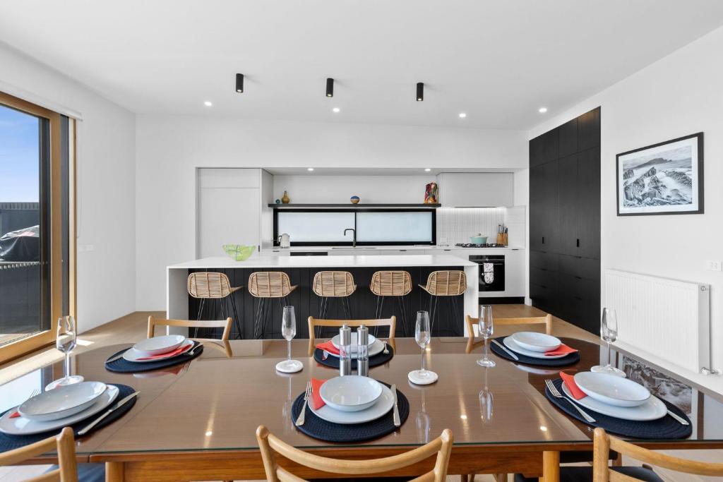 a kitchen and dining room with a table and chairs at REFLECTIONS at Lonsdale in Point Lonsdale