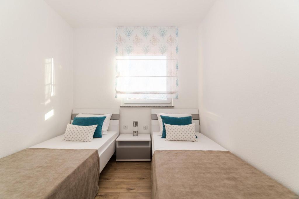 Postel nebo postele na pokoji v ubytování Apartments Kovacevic