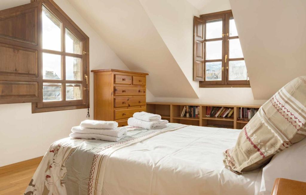 ein Schlafzimmer mit einem Bett mit Handtüchern darauf in der Unterkunft Ático B Residencial Caldares El Pueyo in El Pueyo de Jaca