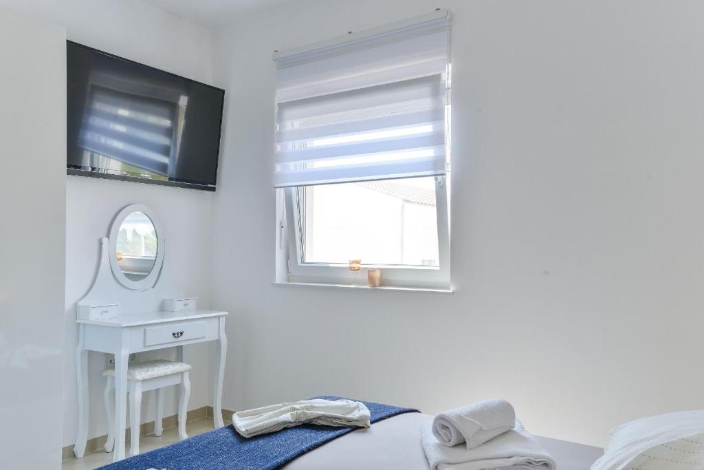 Posteľ alebo postele v izbe v ubytovaní Apartments Olujic