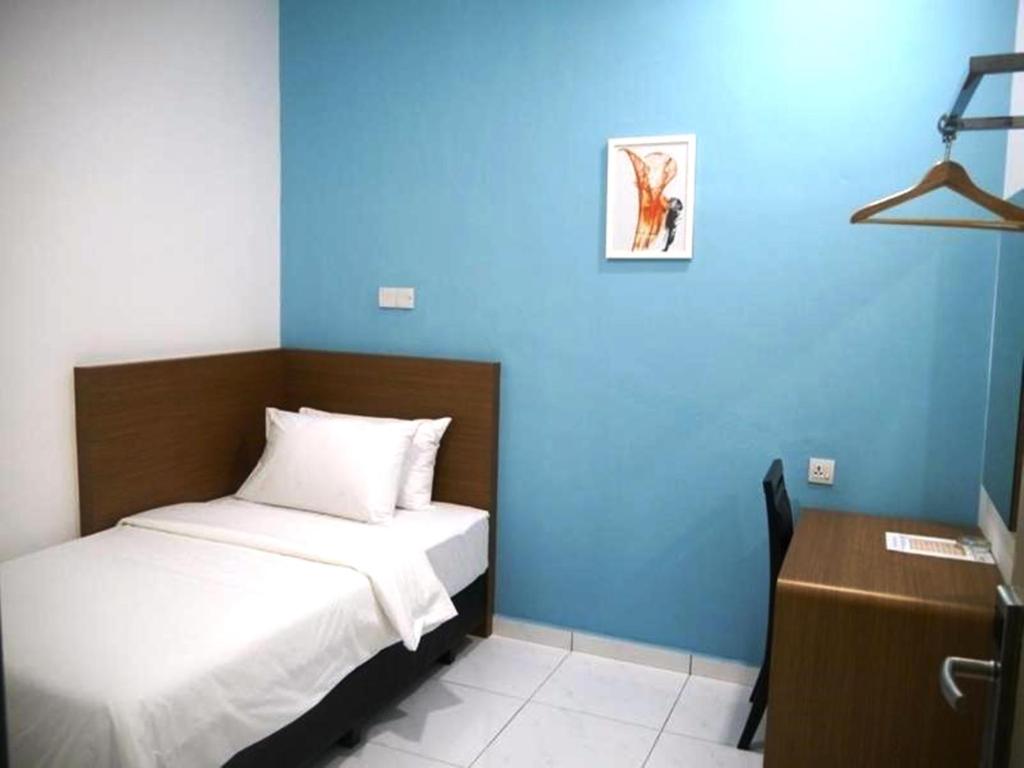 Postel nebo postele na pokoji v ubytování Hotel Wawasan